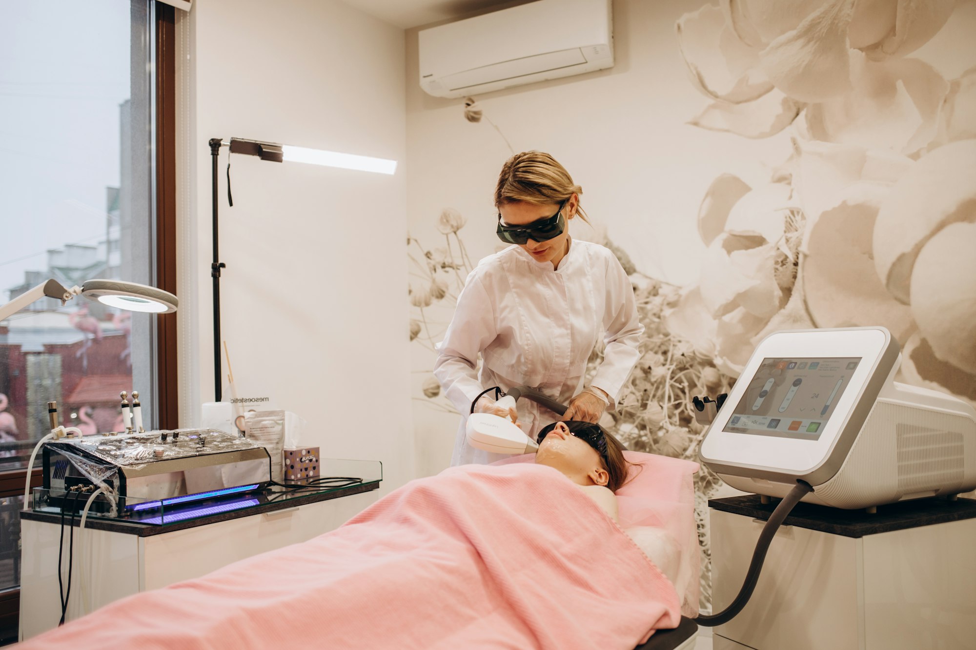 Beautiful woman having her facial hair removed by female beautician. Lazer epilation treatment