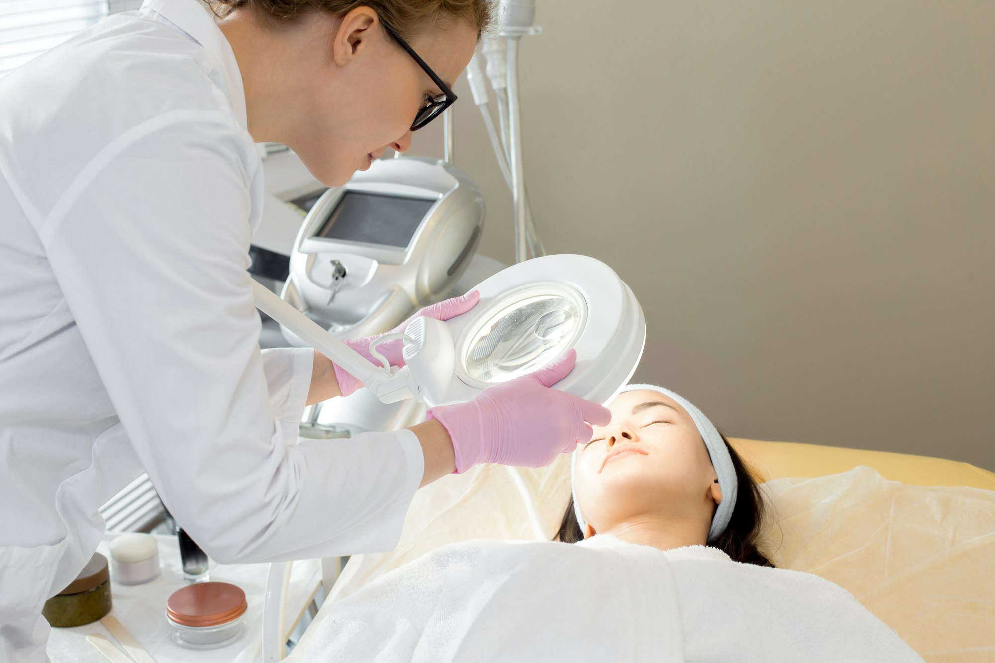 Cosmetologist Inspecting Skin