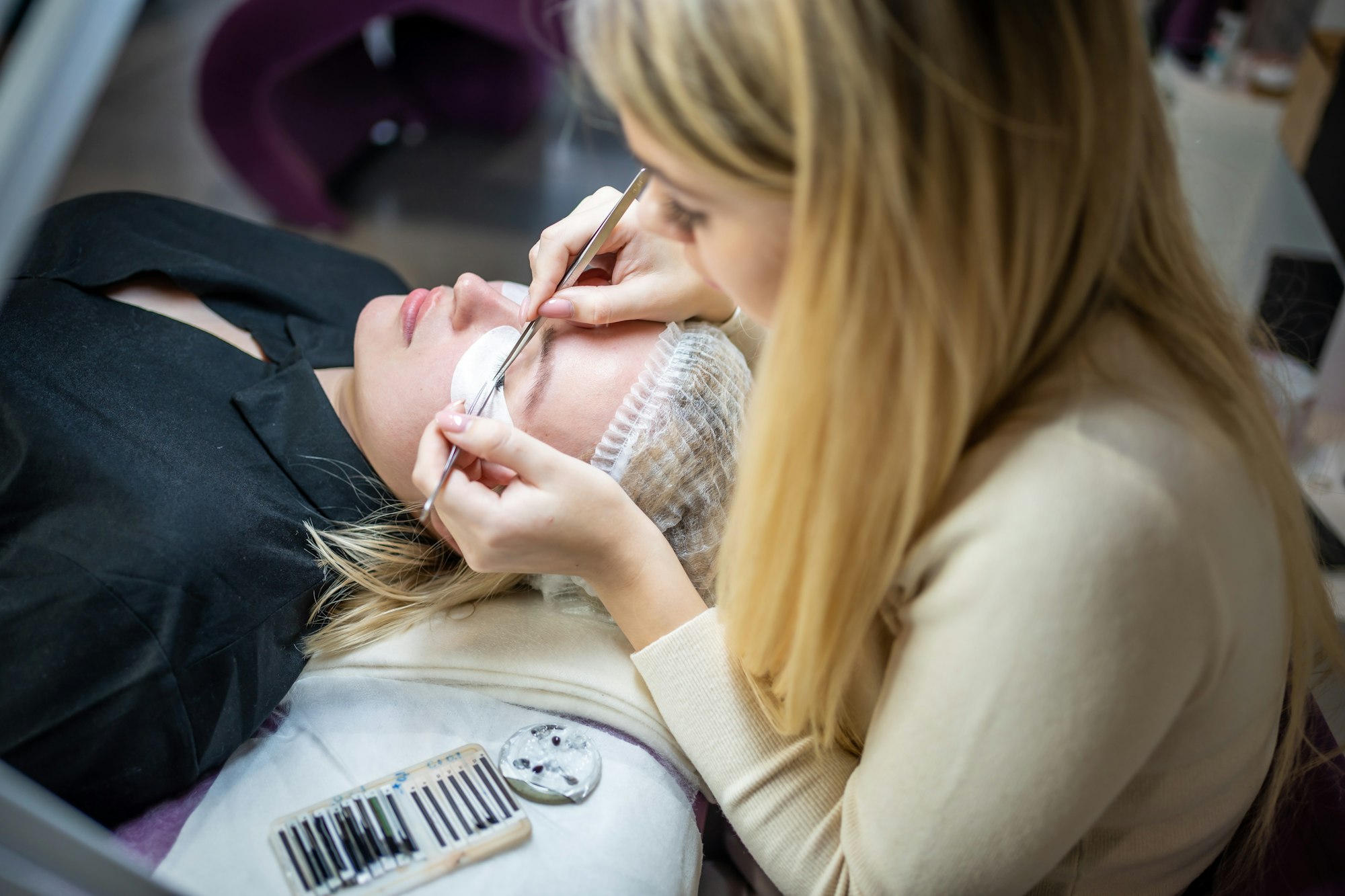 Eyelash extension procedure in beauty salon. Lashes close up. Concept spa lash.