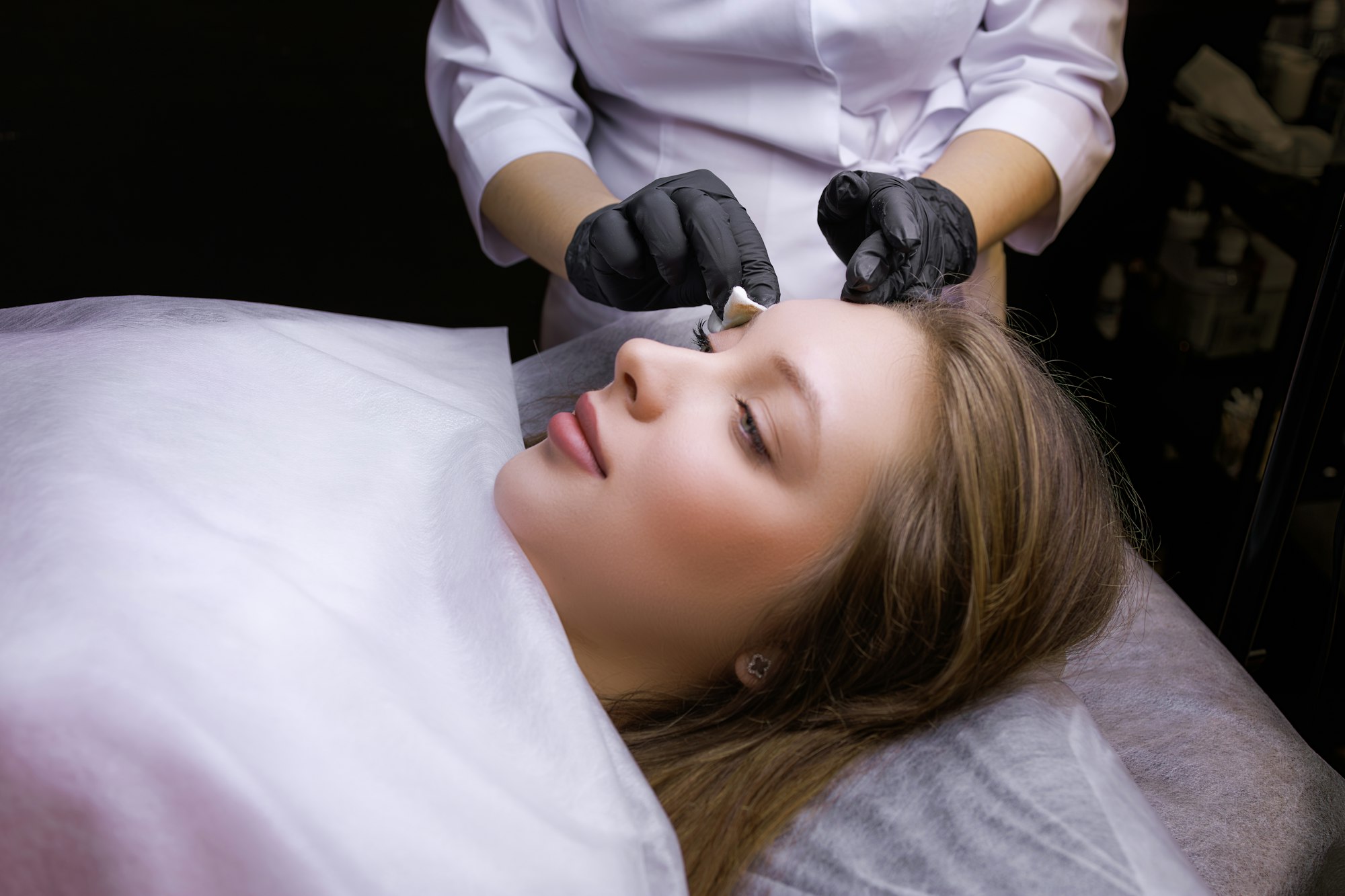 Preparation of the model's eyebrows for the procedure of permanent makeup.