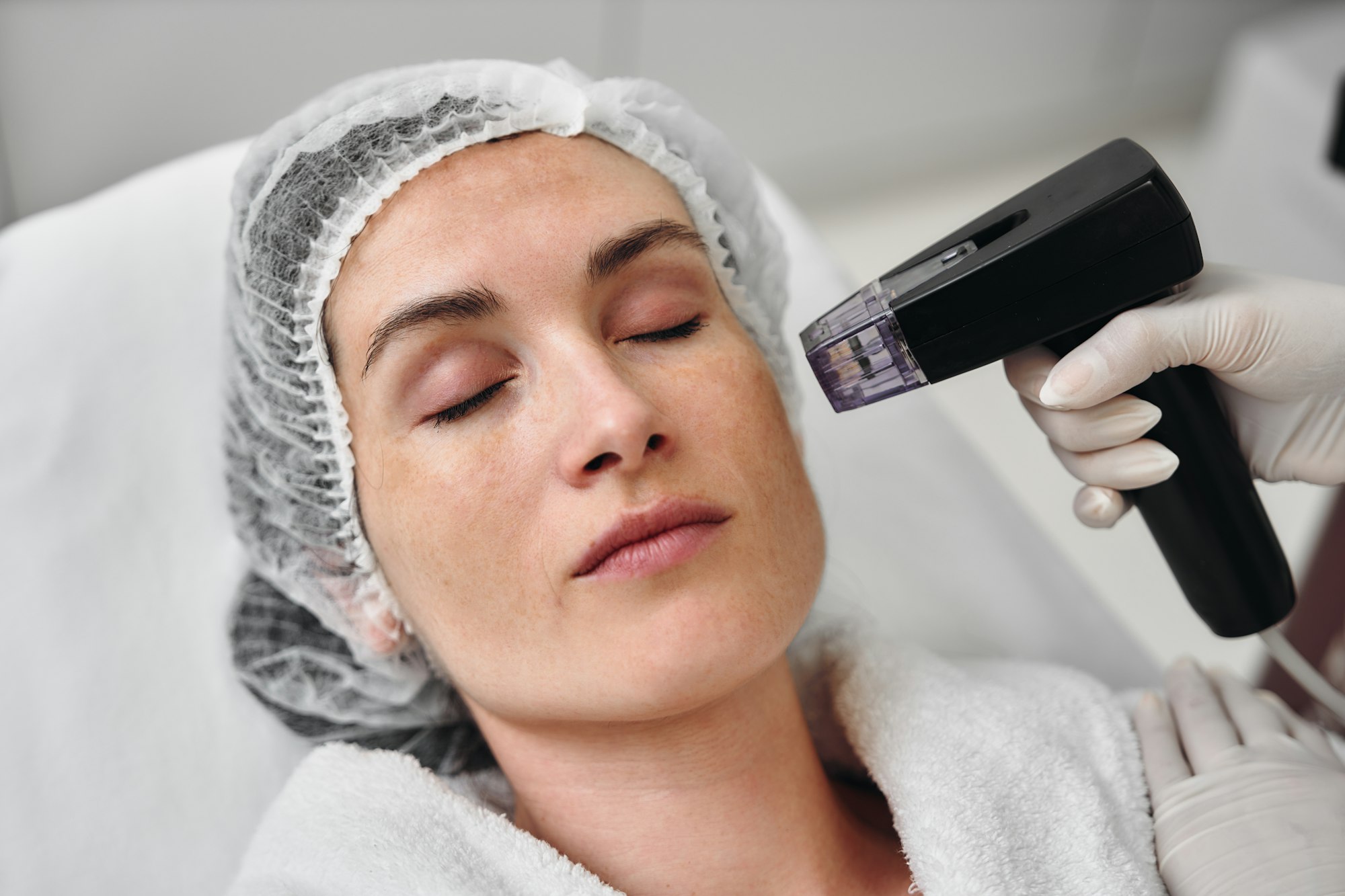 Woman receiving dermatological treatment in a clinical setting